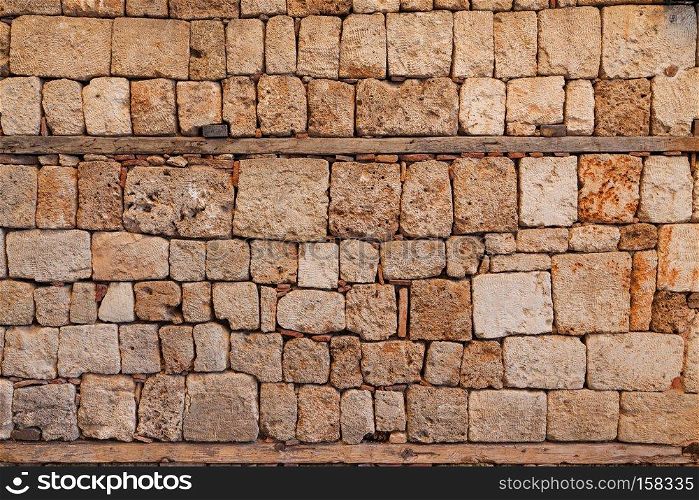 Background of stone fence wall of sandstone bricks. Background of stone wall texture