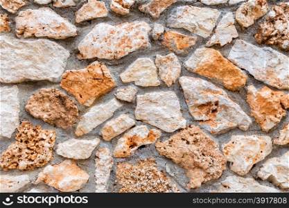 Background of stony wall with cement as fence in Greece