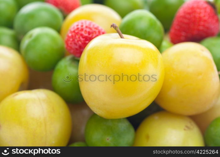 background of strawberry, green and yellow plum