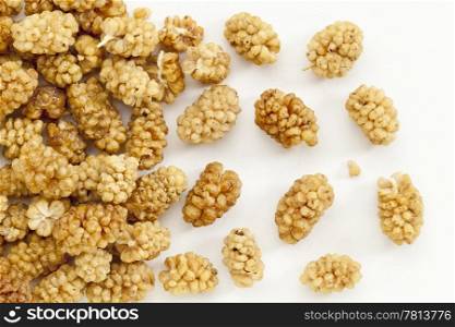 background of sun-dried white mulberry berries on an artist canvas