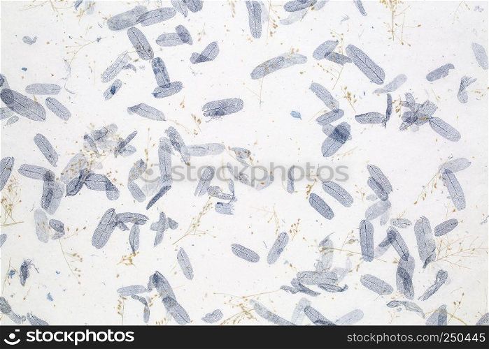 background of textured handmade mulberry paper with leaves and petals