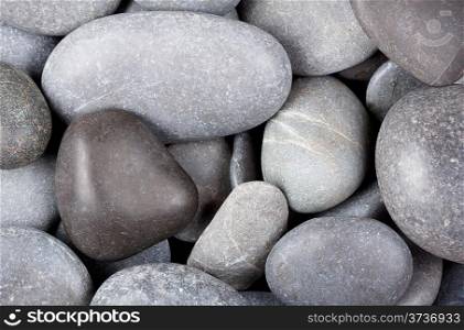 Background of the dark sea of round stones