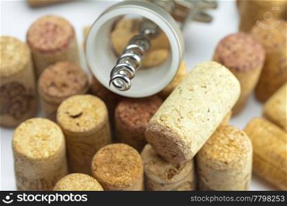 background of the mountains of wine corks and a corkscrew