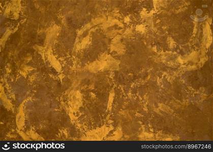 background of the plastered texture with marble effect gold color. artistic background handmade. colorful artistic background