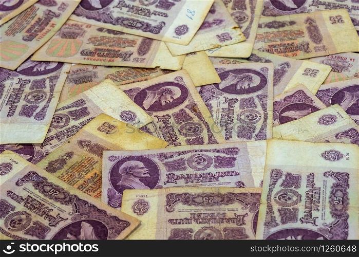 Background of twenty-five ruble bills of Soviet money of the 1961 sample, shot in close-up.