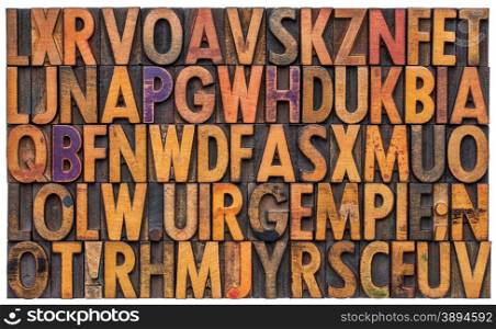 background of vintage letterpress wood type printing blocks, random letters of alphabet and punctuation stained by color inks, isolated on white