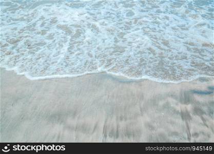 background of waves beating on a sandy beach in stormy weather