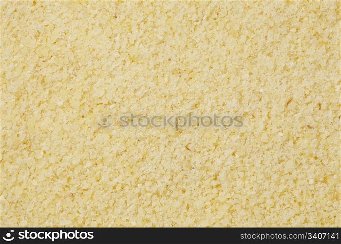 background of yellow semolina wheat flour at life-size magnification