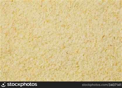 background of yellow semolina wheat flour at life-size magnification