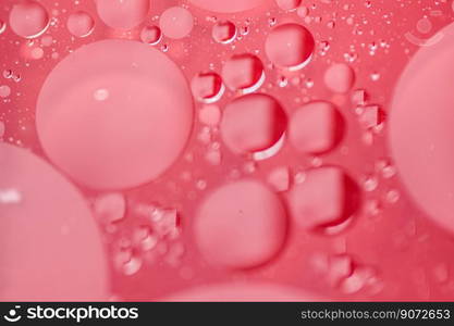 Background  Oil drops on water , on a red tray 