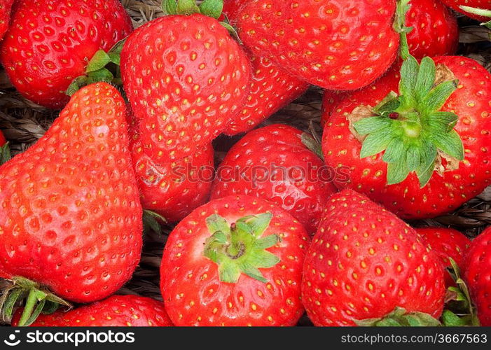 Background on fresh ripe strawberries fruit in basket freshly picked