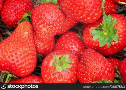 Background on fresh ripe strawberries fruit in basket freshly picked