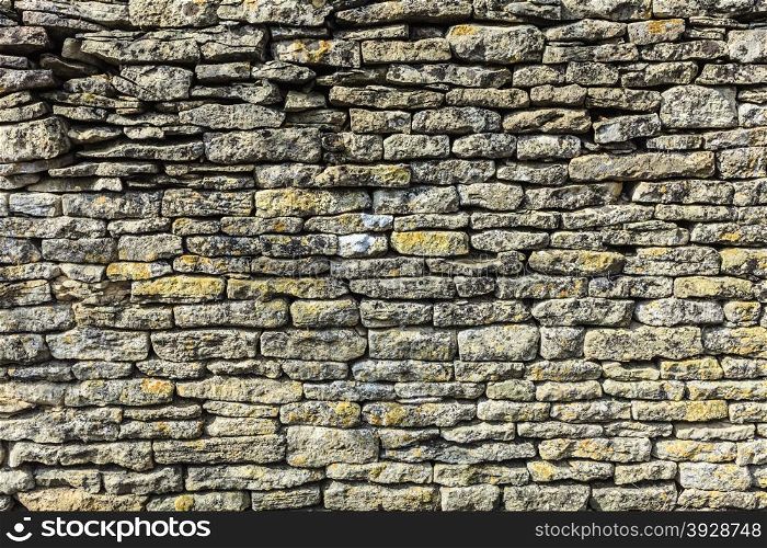 Background or texture pattern gray color of retro vintage design decorative uneven cracked stone wall surface
