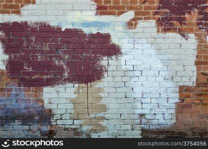 background texture of a grunge brick wall with graffiti painted over