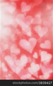 Background texture of blurry and grainy hearts.