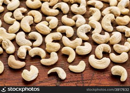 background texture of cashew nuts on a rustic weathered wood