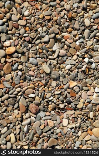 Background texture of little stones from beach sea shore coastline