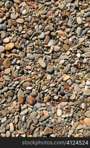 Background texture of little stones from beach sea shore coastline