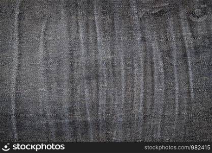 Background texture of old jeans with a pattern of wrinkles.
