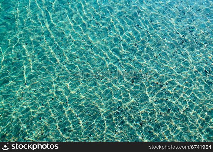 Background - the seabed through the sparkling clear water