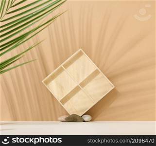 background to showcase products, cosmetics, drinks and food. Beige background with shade from palm leaf