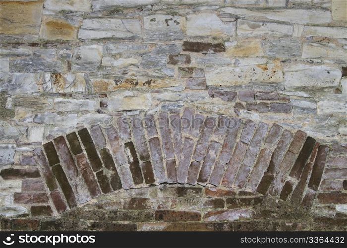background wall with brick insertion. background or texture of a stone wall with brick insertion