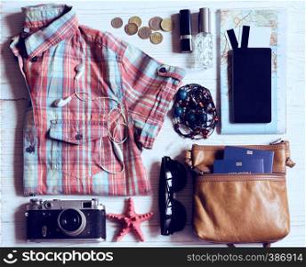 background - what to take for a trip. passport, phone, documents, map, camera, money, sunglasses, credit cards, clothes