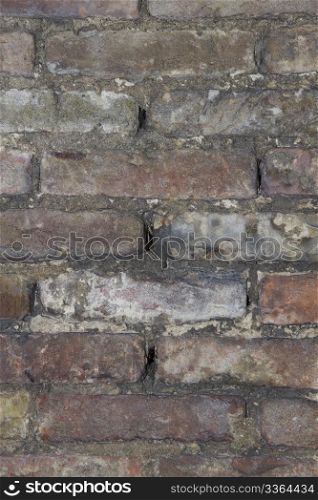 background wheathered an repaired brick wall. background or texture of a old wheathered an repaired brick wall