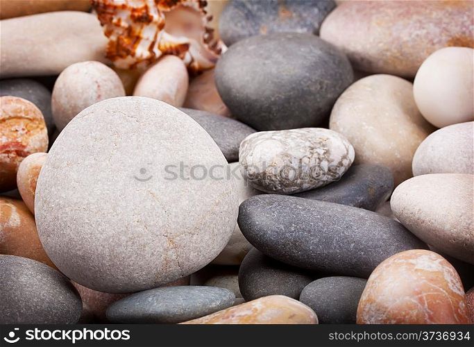 Background with a large round stone on the shingle