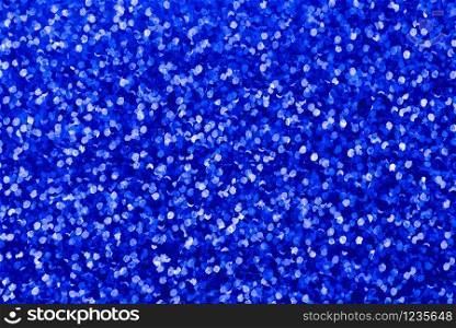 Background with blue sequin texture. Glitter background for Holiday and party banner. Abstract glitter poster with blinking lights. Fabric sequins in bright colors.. Background with blue sequin texture. Glitter background for Holiday and party banner