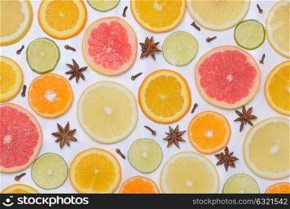 Background with citrus fruit slices, anise star and Clove