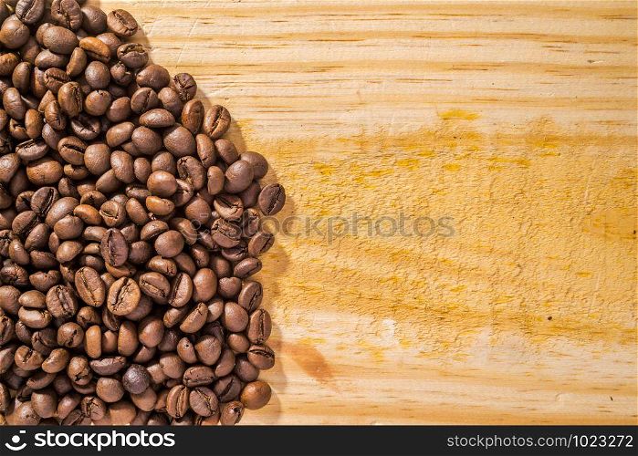 Background with coffee beans and light wood texture