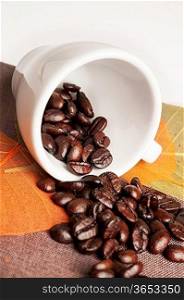 Background with coffee cup, autumn leaves and coffee beans