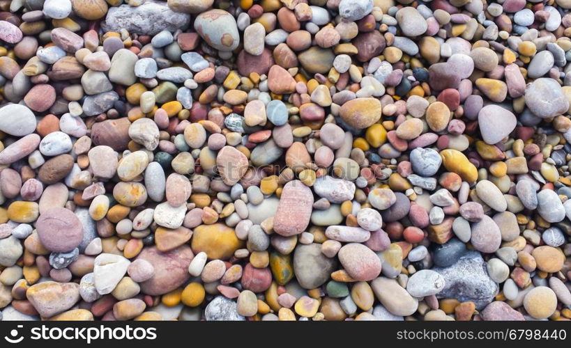 Background with colored stones on a beach