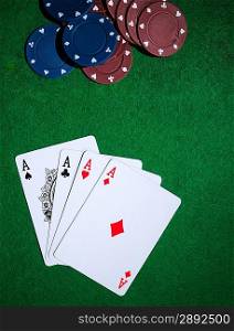 Background with four aces, playng cards and poker chips.