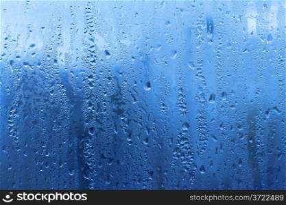 Background with natural water drops on glass