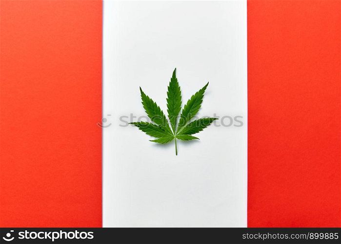 Background with red and white flag of Canada with cannabis leaf instead of maple leaf symbolizing legalize of medical marijuana in country. Altered Canadian flag with green cannabis leaf