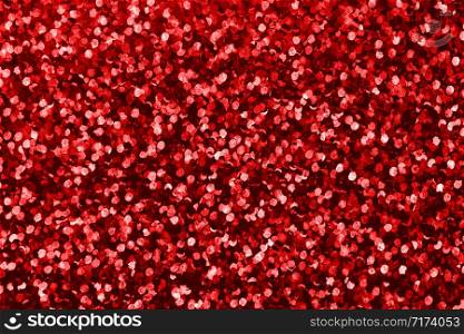 Background with red sequin texture. Glitter background for Holiday and party banner. Abstract glitter poster with blinking lights. Fabric sequins in bright colors.. Background with red sequin texture. Glitter background for Holiday and party banner.