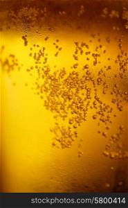 Background with yellow beer and bubbles closeup