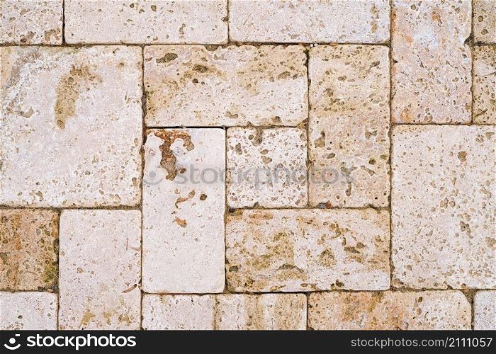 Background with yellow stitched clay natural sandstone tiles. Natural natural stone for interior and renovation. Laying sidewalks and roads