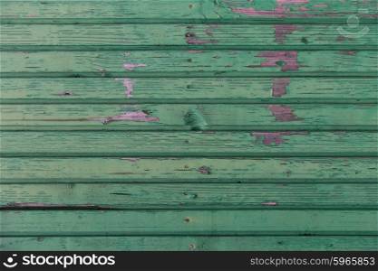 backgrounds and texture concept - old wooden fence painted in green background. old wooden boards painted in green background