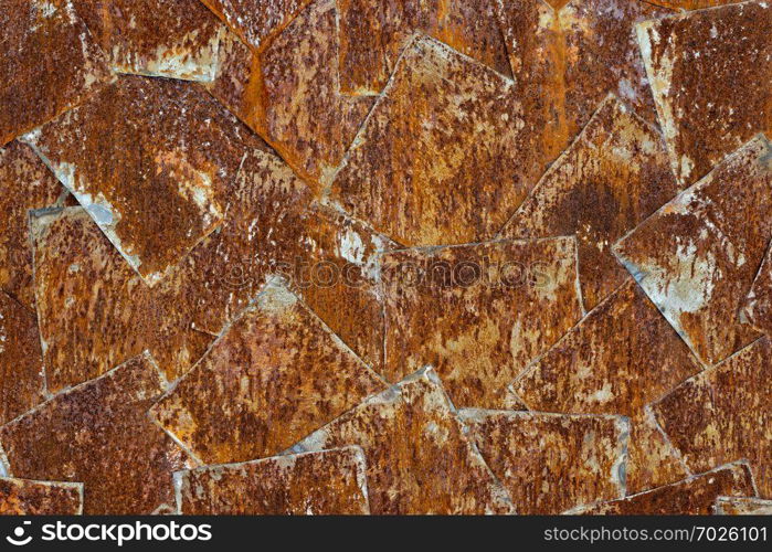 Backgrounds and textures: arrangement of rusty metal sheets, abstract pattern. Abstract rusty background