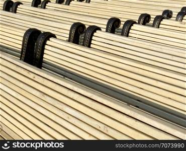 Backgrounds and textures: big group of park benches, new and clean, arranged in rows. Group of park benches