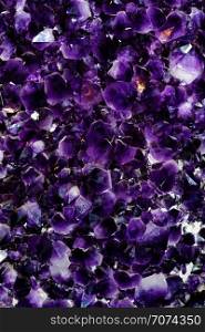 Backgrounds and textures: druse of beautiful purple amethyst crystals, semiprecious stone, natural abstract background. Purple amethyst crystals