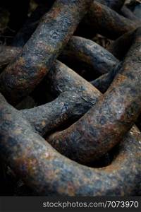 Backgrounds and textures: links of old black rusty chain, close-up shot, industrial abstract. Old black chains