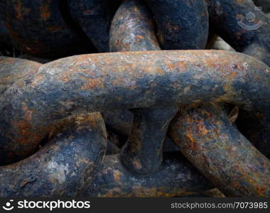 Backgrounds and textures: links of old black rusty chain, close-up shot, industrial abstract. Old black chains