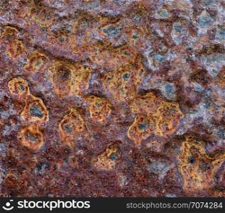 Backgrounds and textures: old rusty metal wall surface with dents, industrial abstract. Old rusty metal wall surface