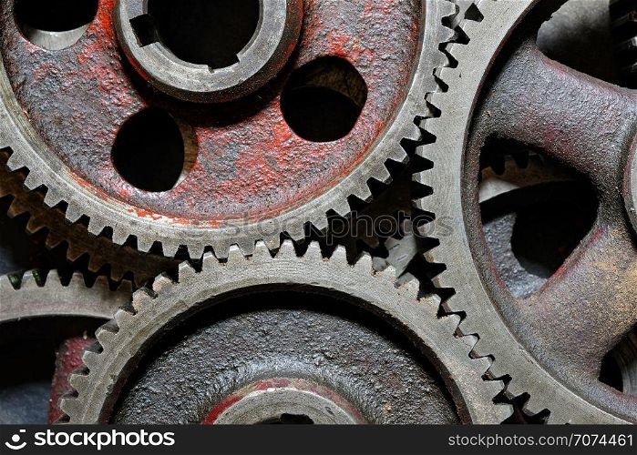 Backgrounds and textures: set of connected steel cogwheels, big, heavy and old, industrial abstract. Group of old steel cogwheels