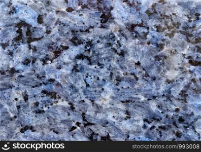 Backgrounds and textures: surface of beautiful blue decorative stone, quartz crystals and abstract pattern of cracks, spots and stains, natural background. Abstract mineral texture with quartz crystals