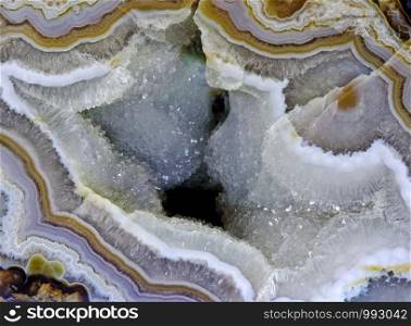 Backgrounds and textures: surface of beautiful decorative stone, quartz crystals and abstract pattern of cracks, spots and stains, natural background. Abstract mineral texture with quartz crystals